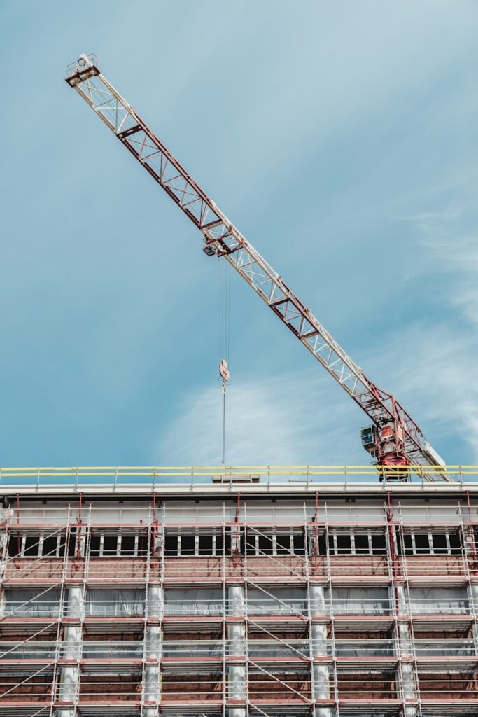 gray and brown crane on top of building