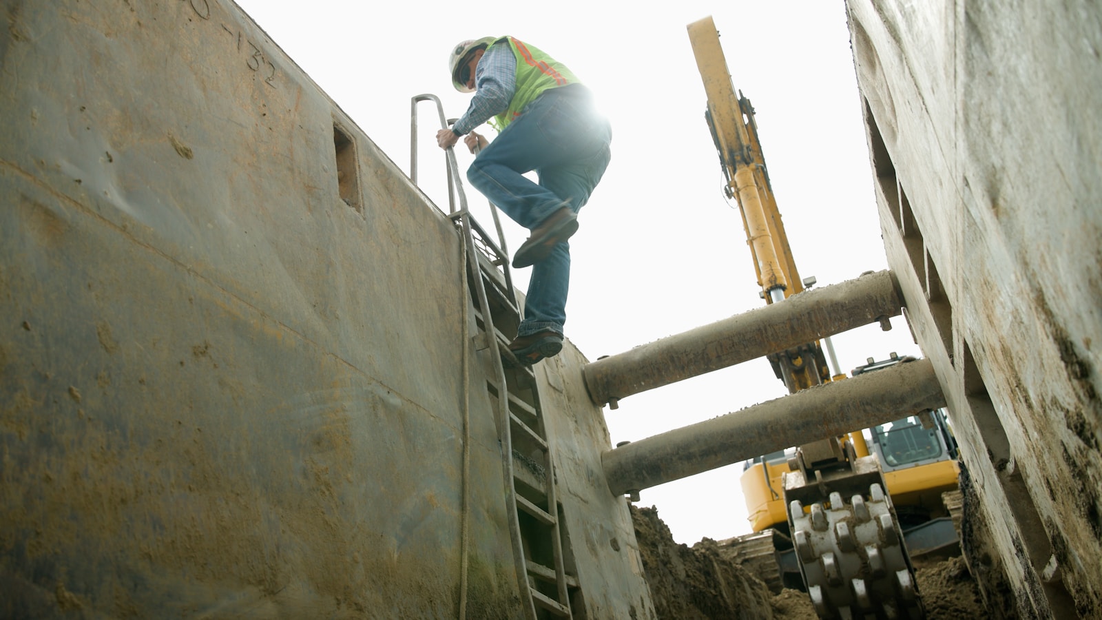 Construction worker climbs out of a deep trench. Exploring (construction engineering): Where Innovation Meets Practical Design