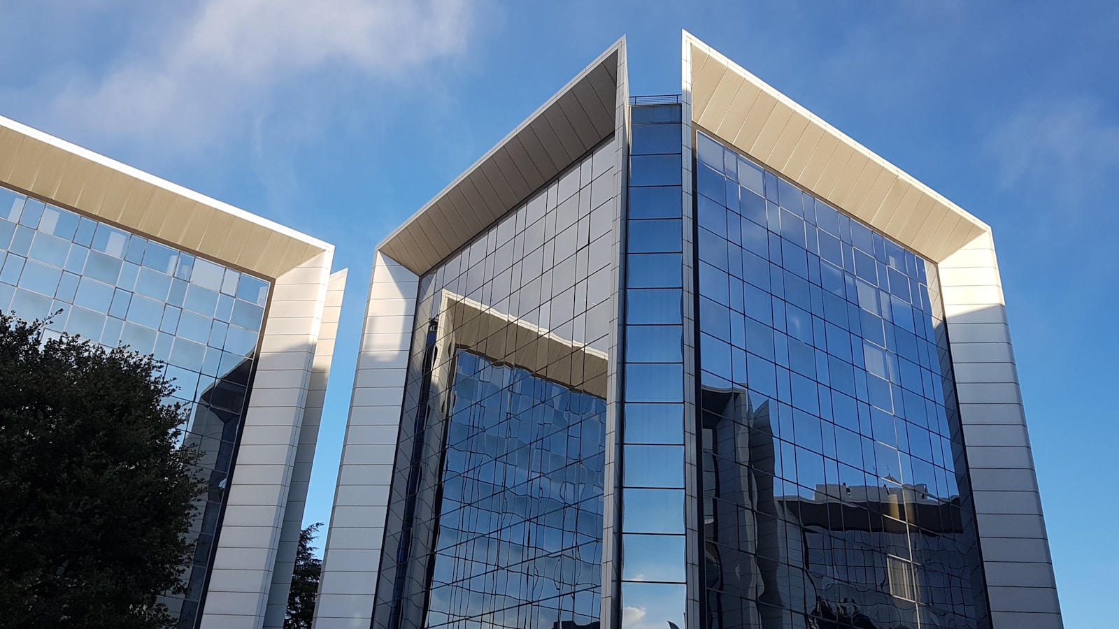 blue and white glass walled building under blue sky during daytime Why (commercial construction) Matters for Senior Living and Healthcare Facilities