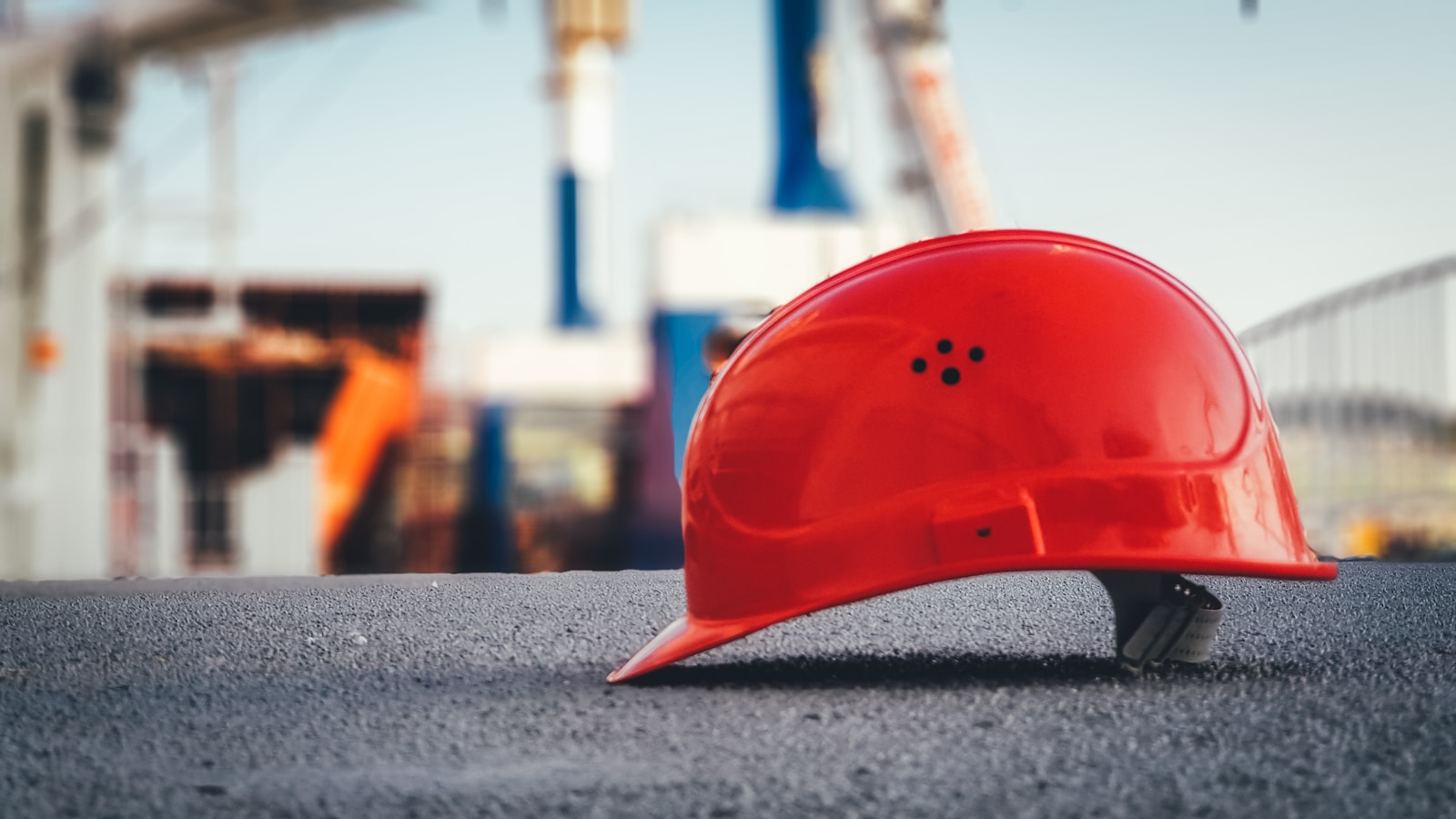 red hard hat on pavement What Is (preconstruction) and Why It’s the Key to a Successful Project