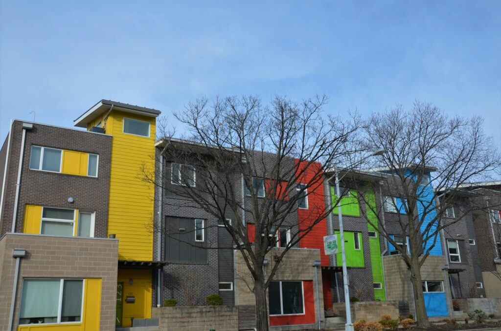 a row of multi - colored houses in a neighborhood