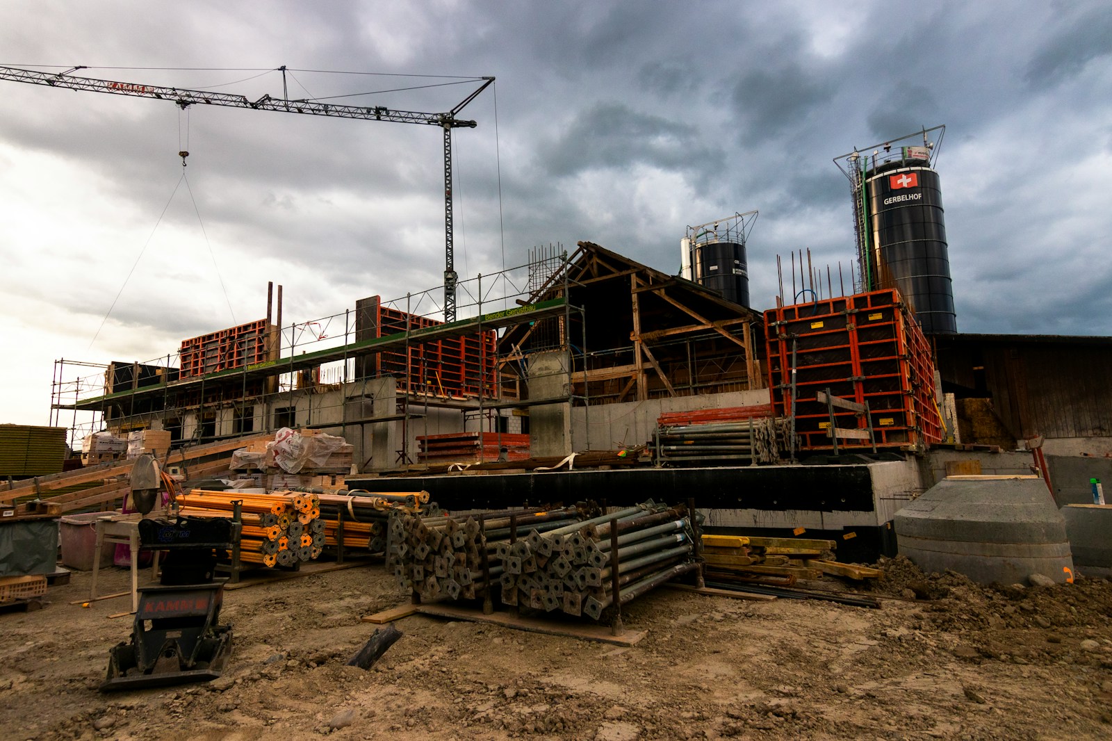 Photo by Jan Huber a construction site with a crane in the background Construction Projects