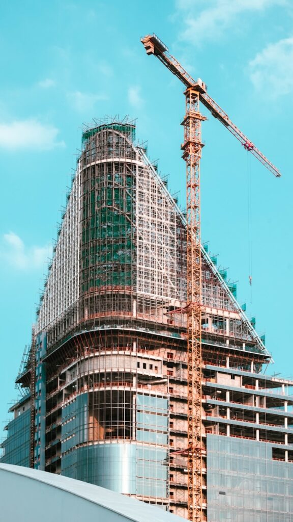 A tall building under construction with a crane.