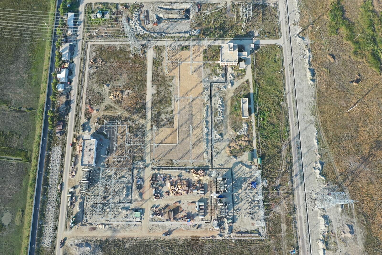 Aerial shot of an industrial construction site in Golbania, showcasing structures and landscape.