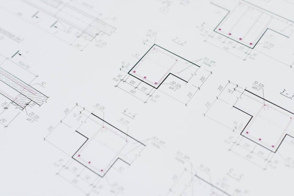 High-resolution close-up of detailed architectural blueprints showcasing precision design layouts.