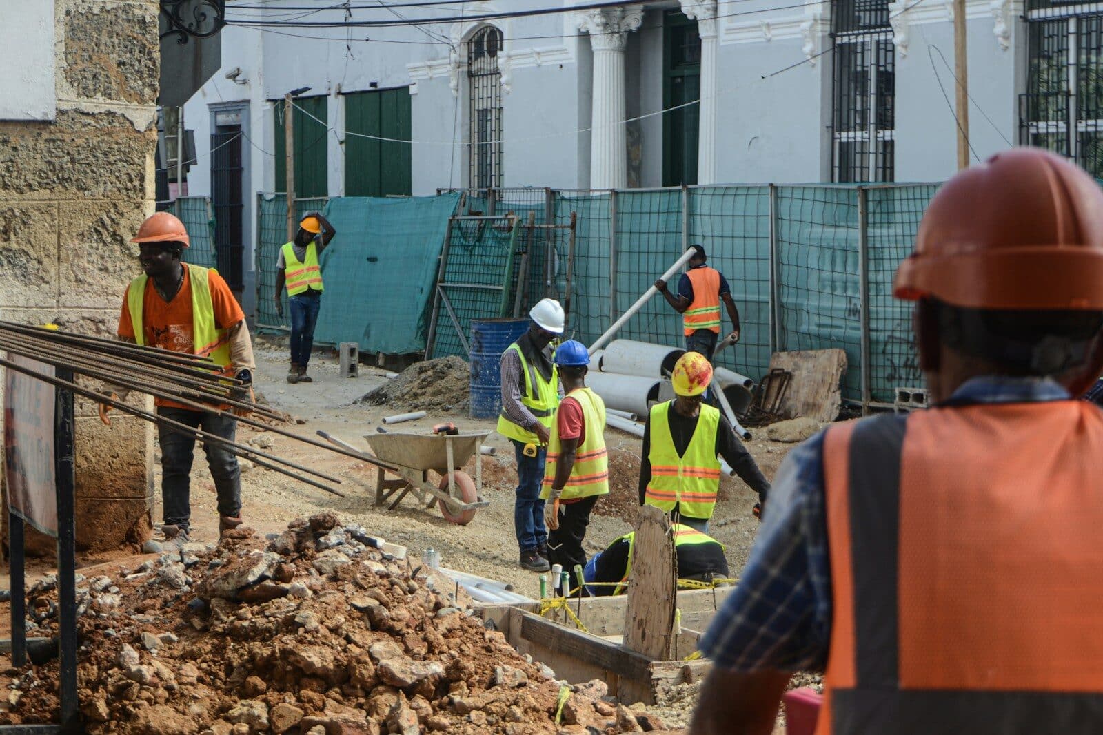 Construction workers in hard hats and safety vests on site