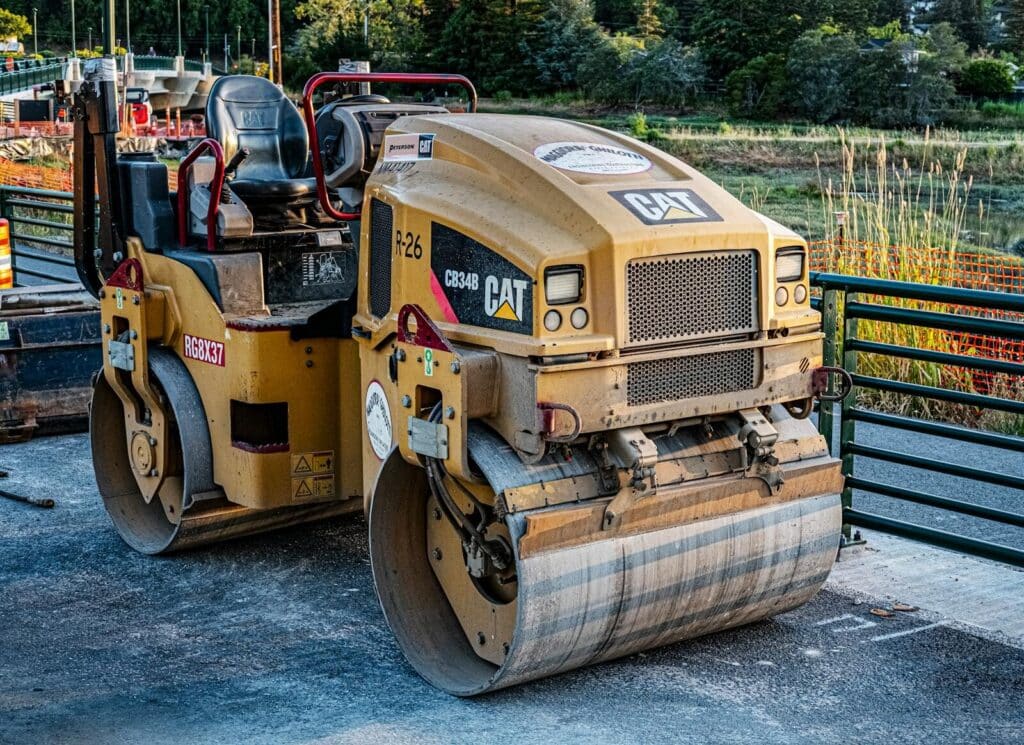 A CAT road roller on an outdoor construction site, perfect for industrial imagery.