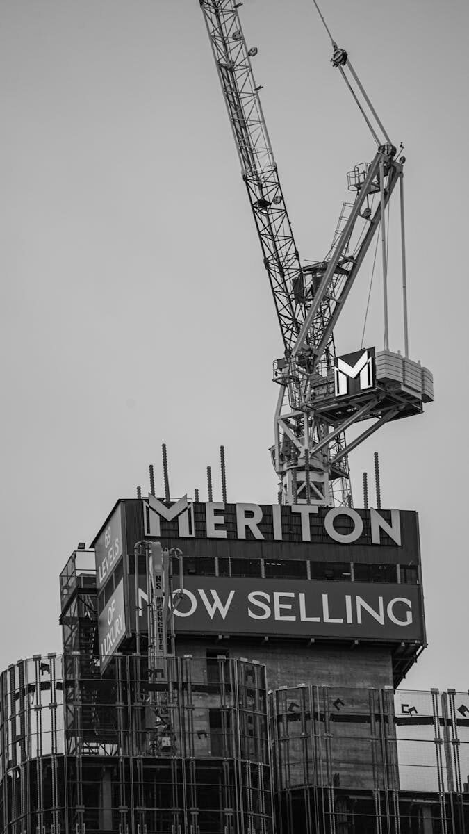 High-rise construction crane at Meriton building site, black and white photo.