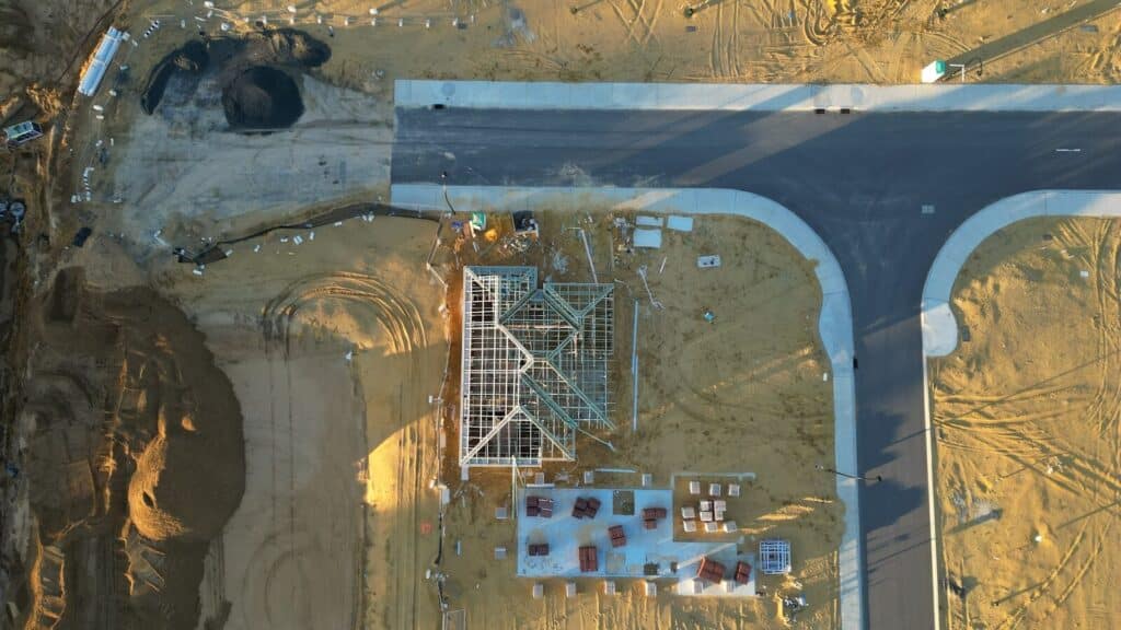 An aerial view of a road and a construction site