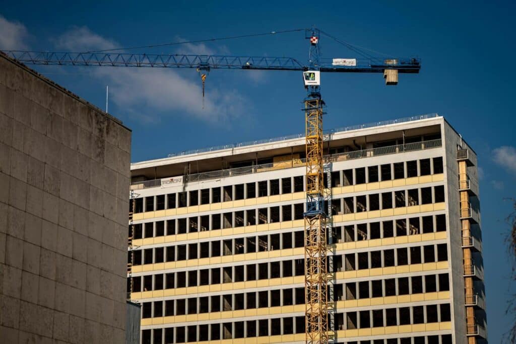 View of a construction crane and building facade in Zagreb, Croatia. Residential Development vs Commercial Development and Other Key Differences