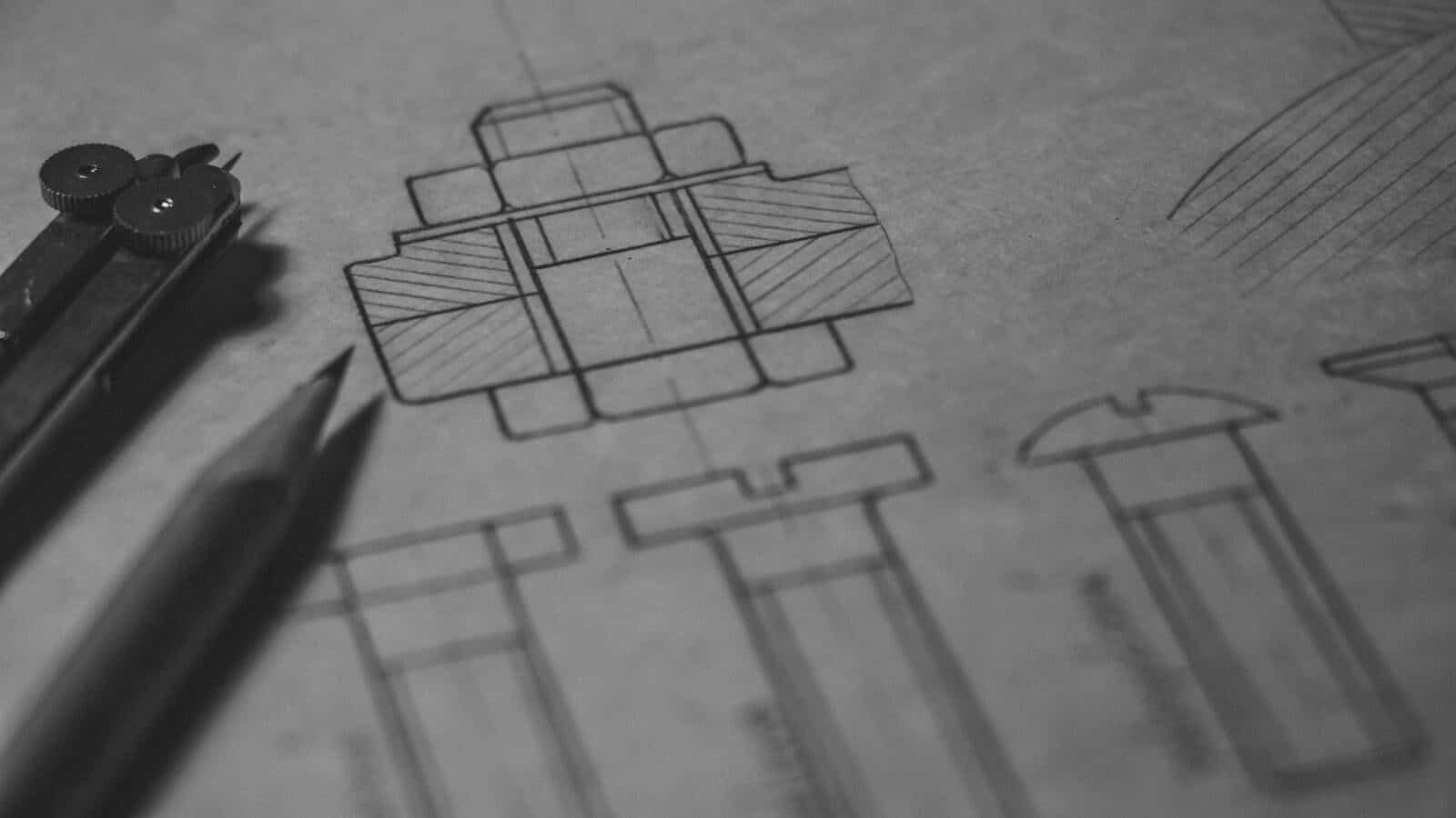 Detailed technical blueprint with pencil and compass illustrating engineering design concepts. Engineering Design and Its Role in Successful Construction Projects