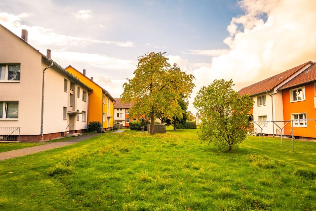 Cozy autumn view of colorful residential buildings and lush greenery in Niedersachsen, Germany.