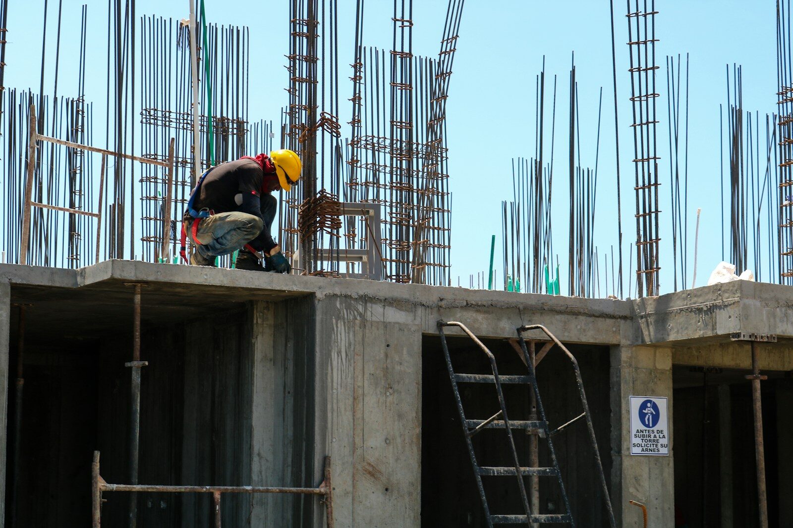 man kneeling on unfinished building during daytime Construction Safety In Commercial Projects: What Owners Should Know