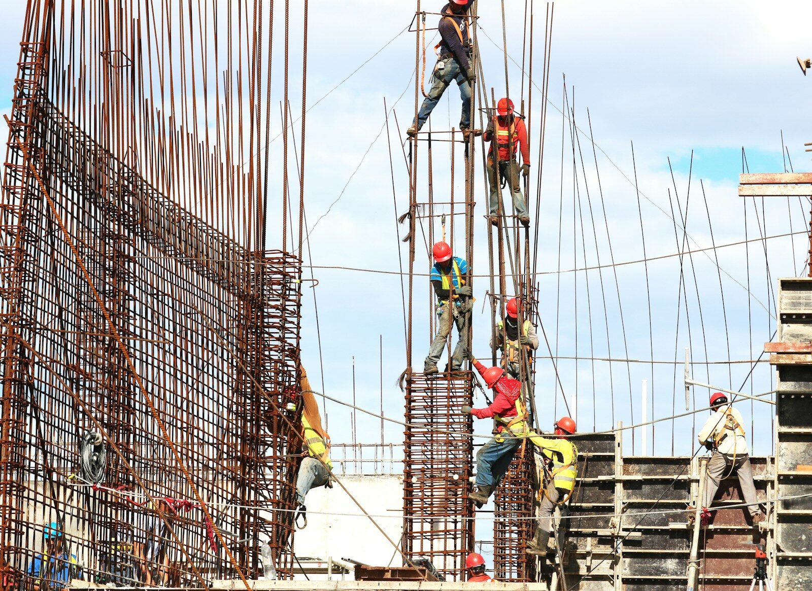 people working on building during daytime The Importance of Construction Safety: Insights from South Coast Improvement Company’s Expertise in Complex Projects